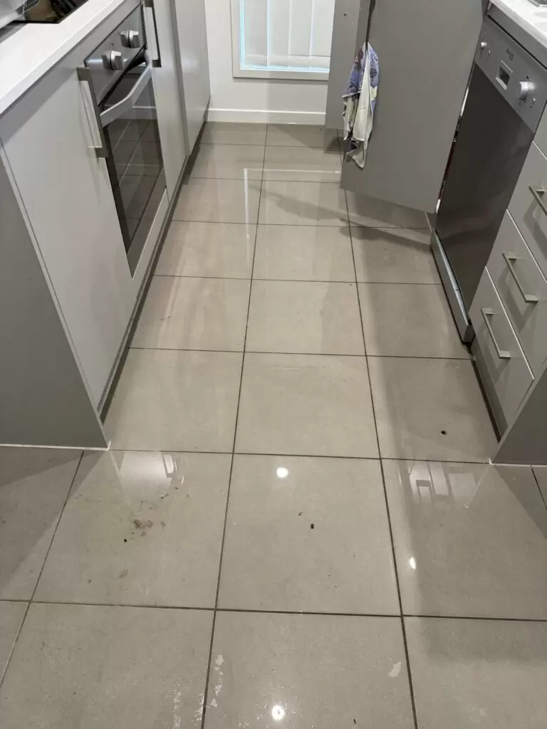Water on kitchen tile floor caused by burst flexi hose under sink in Pimpama Gold Coast