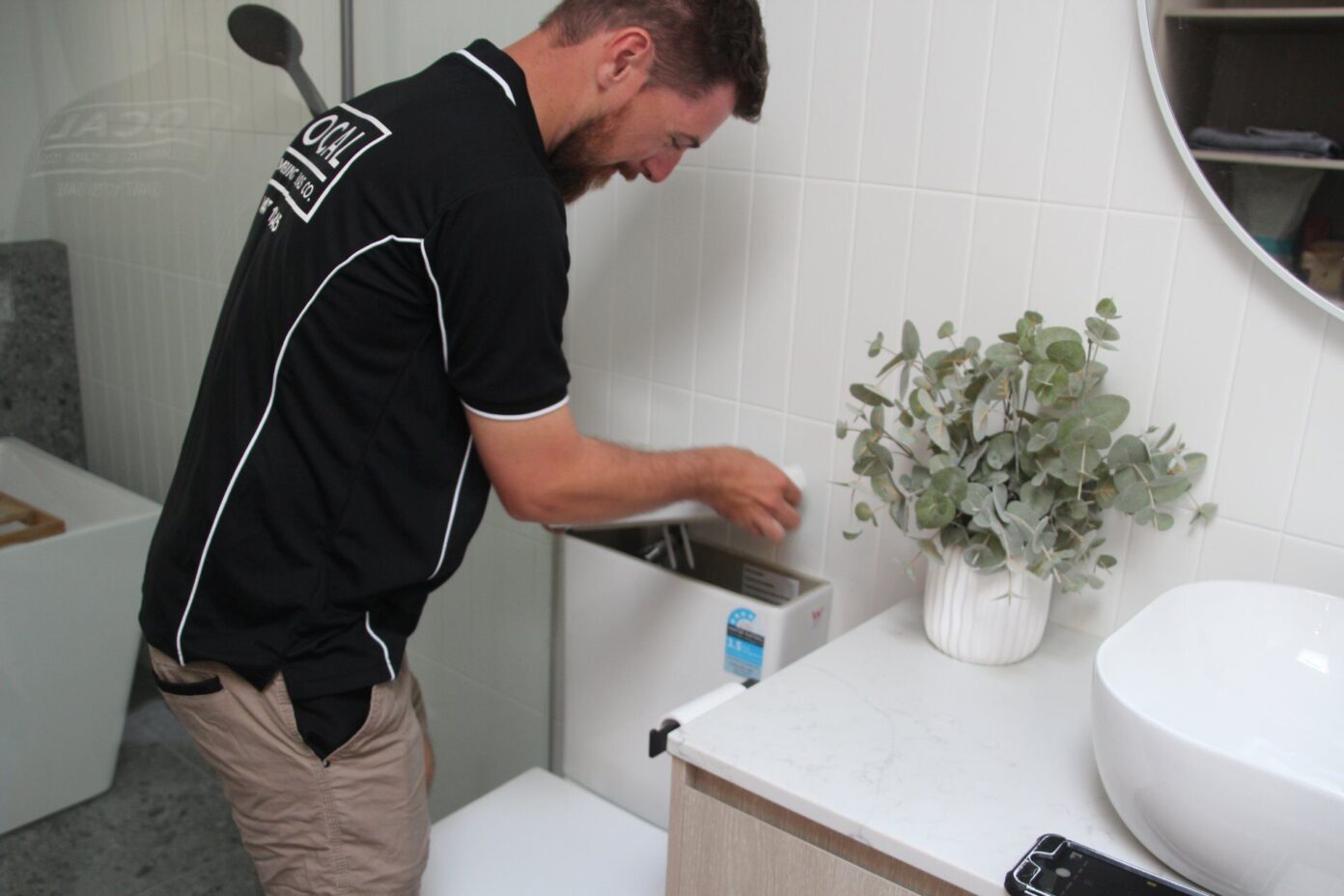 bathroom plumber installing toilet in bathroom renovation on the Gold Coast