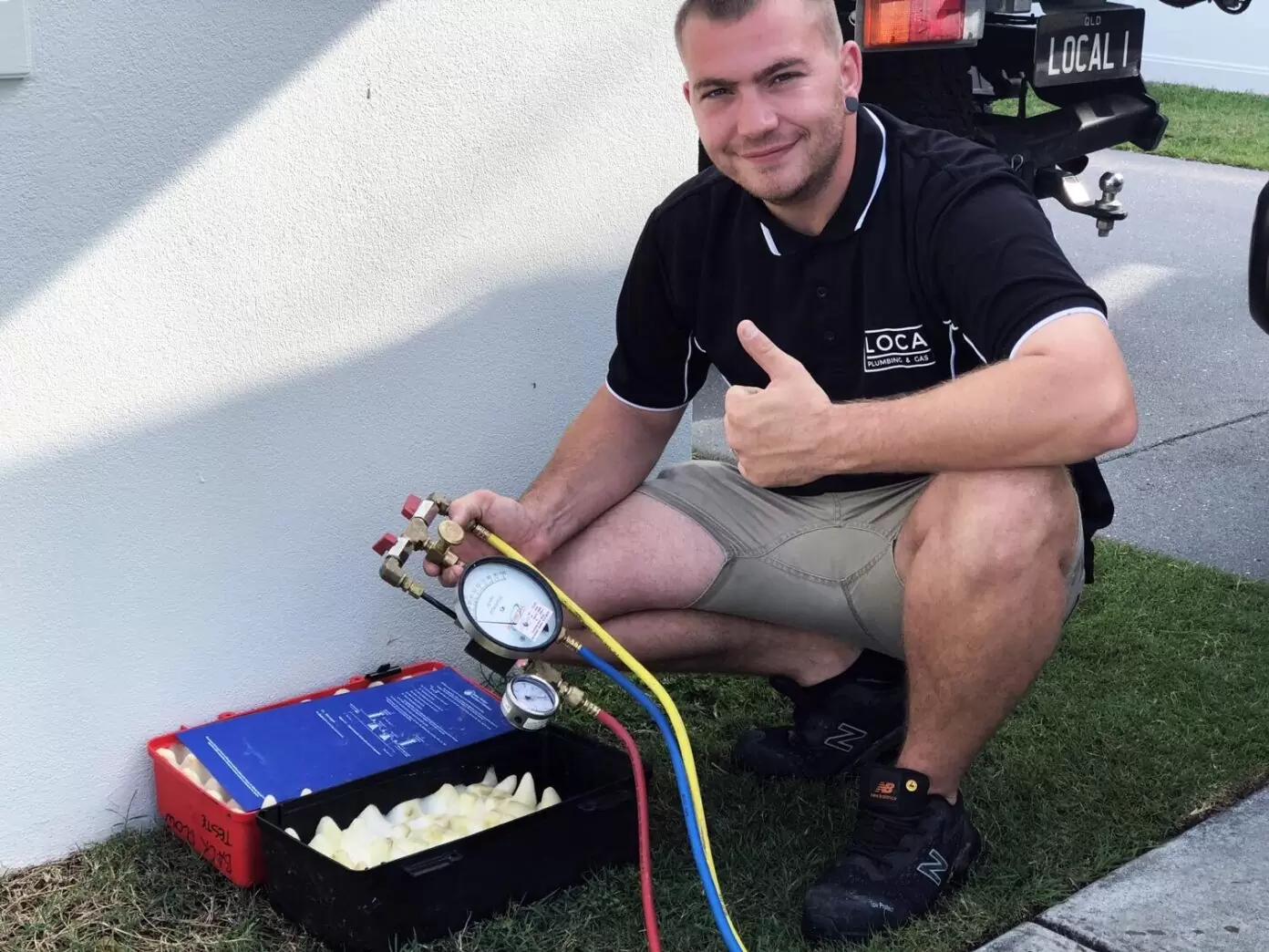 Licensed plumber performing backflow testing on a residential property on the Gold Coast