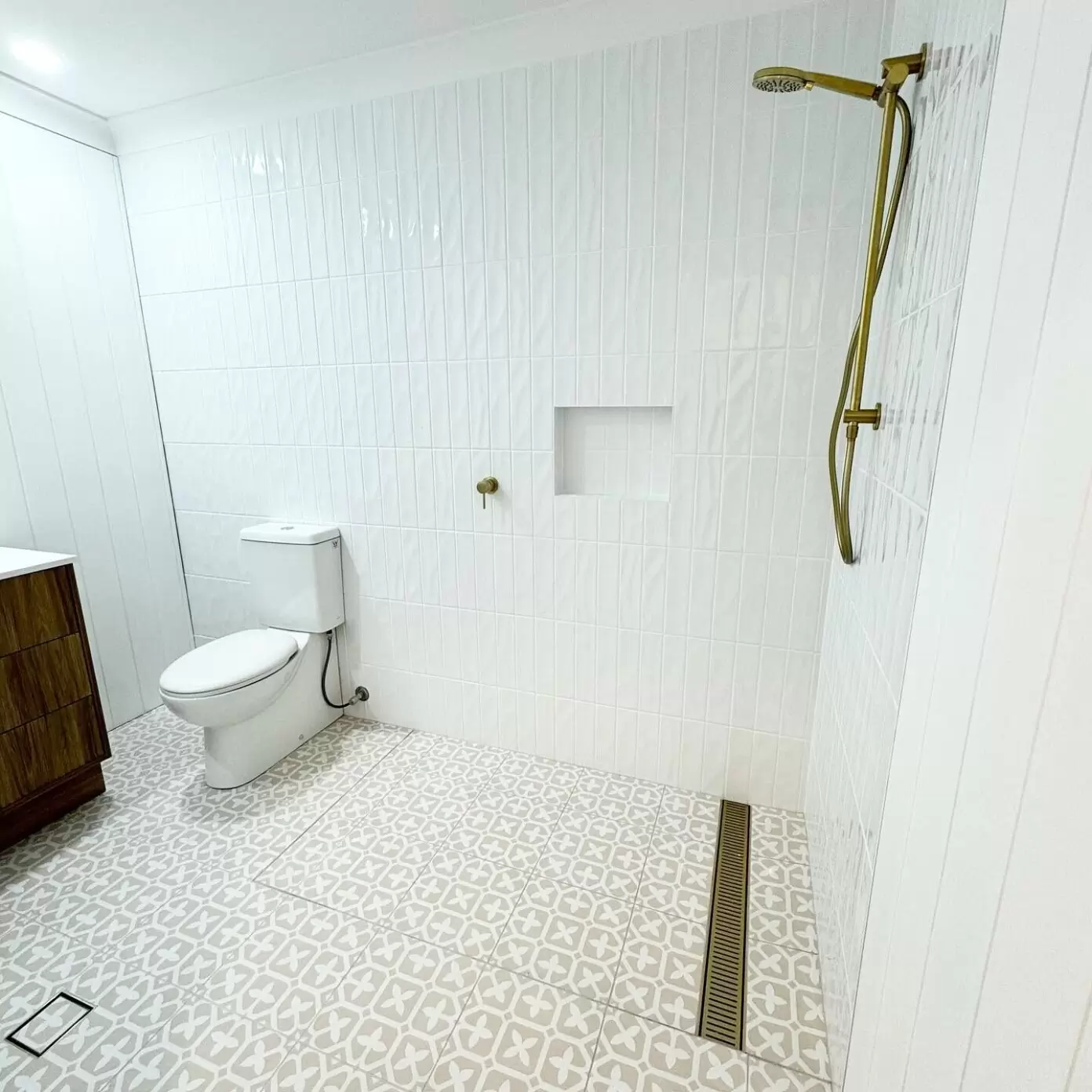 Modern white bathroom renovation with gold fixtures – Sanctuary Cove project by Local Plumbing & Gas Co