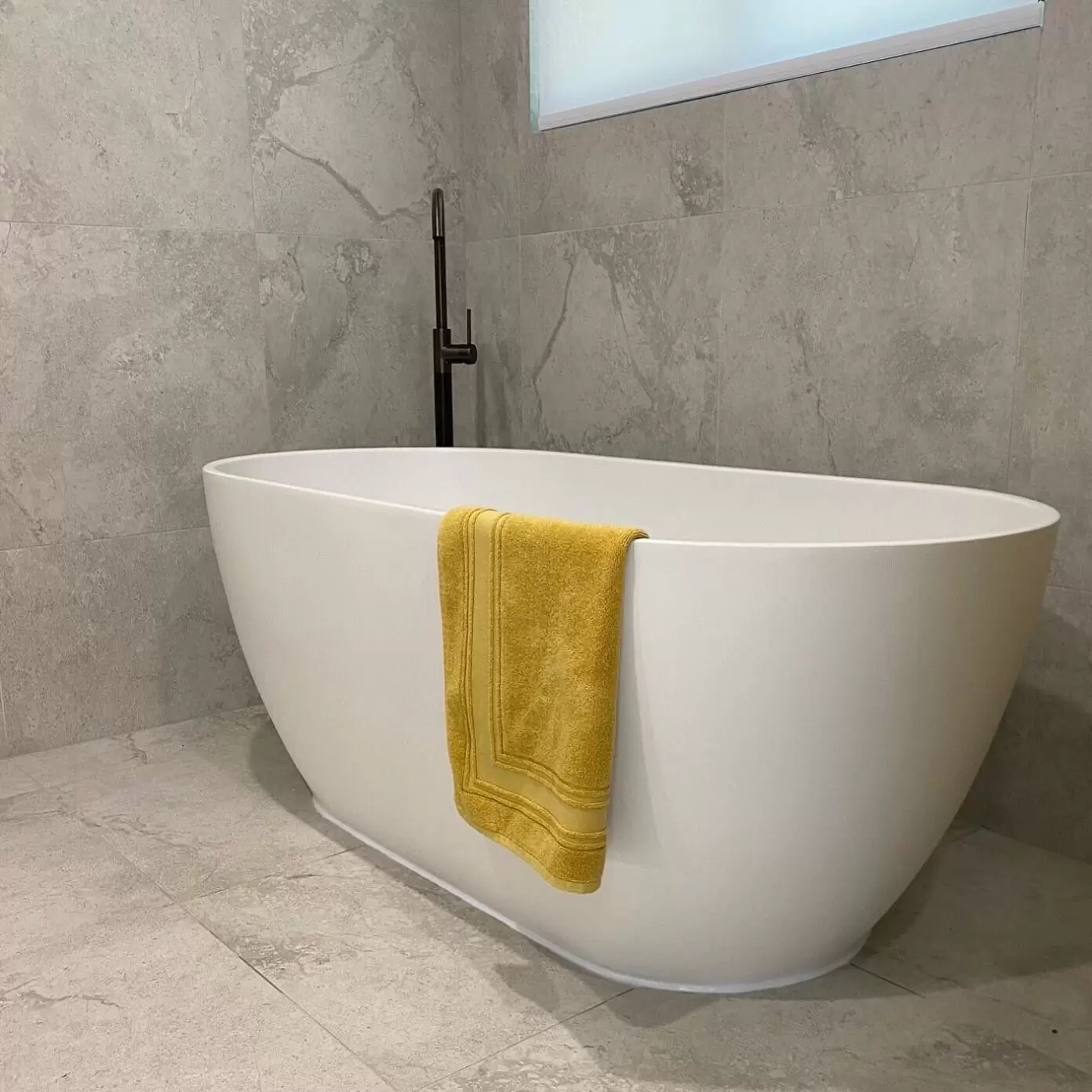 Elegant freestanding bath with matte black tapware in a newly upgraded Mermaid Waters bathroom