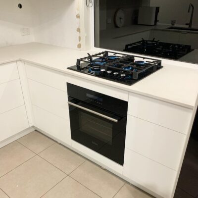 Built-in gas cooktop installed in modern white kitchen.