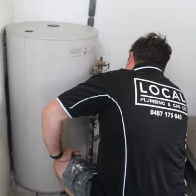 How Water Plumber from Local Plumbing & Gas Co. inspecting a residential hot water system, identifying potential faults or maintenance issues
