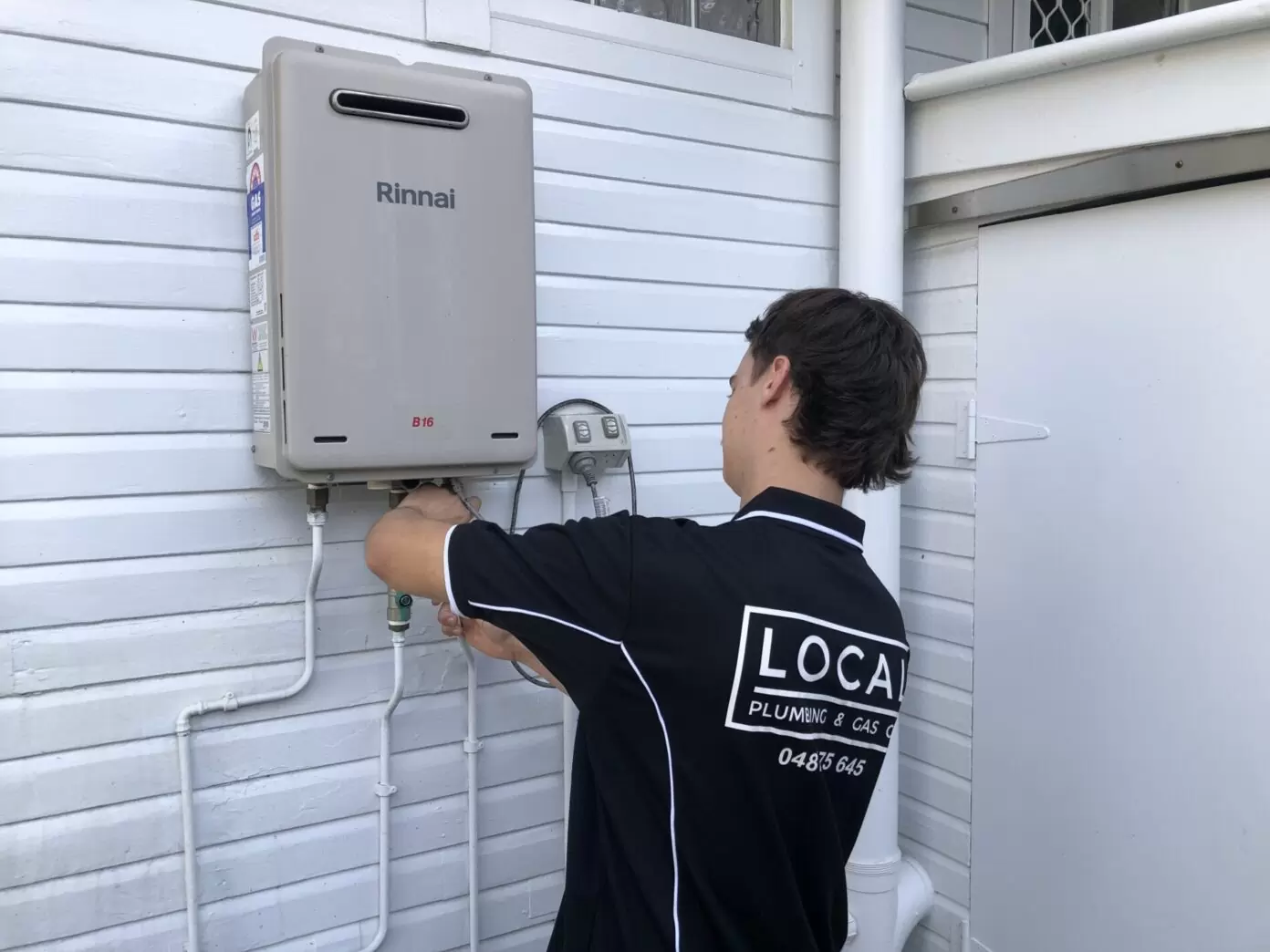 Licensed gas plumber repairing a non-compliant gas hot water system in Highland Park, Gold Coast