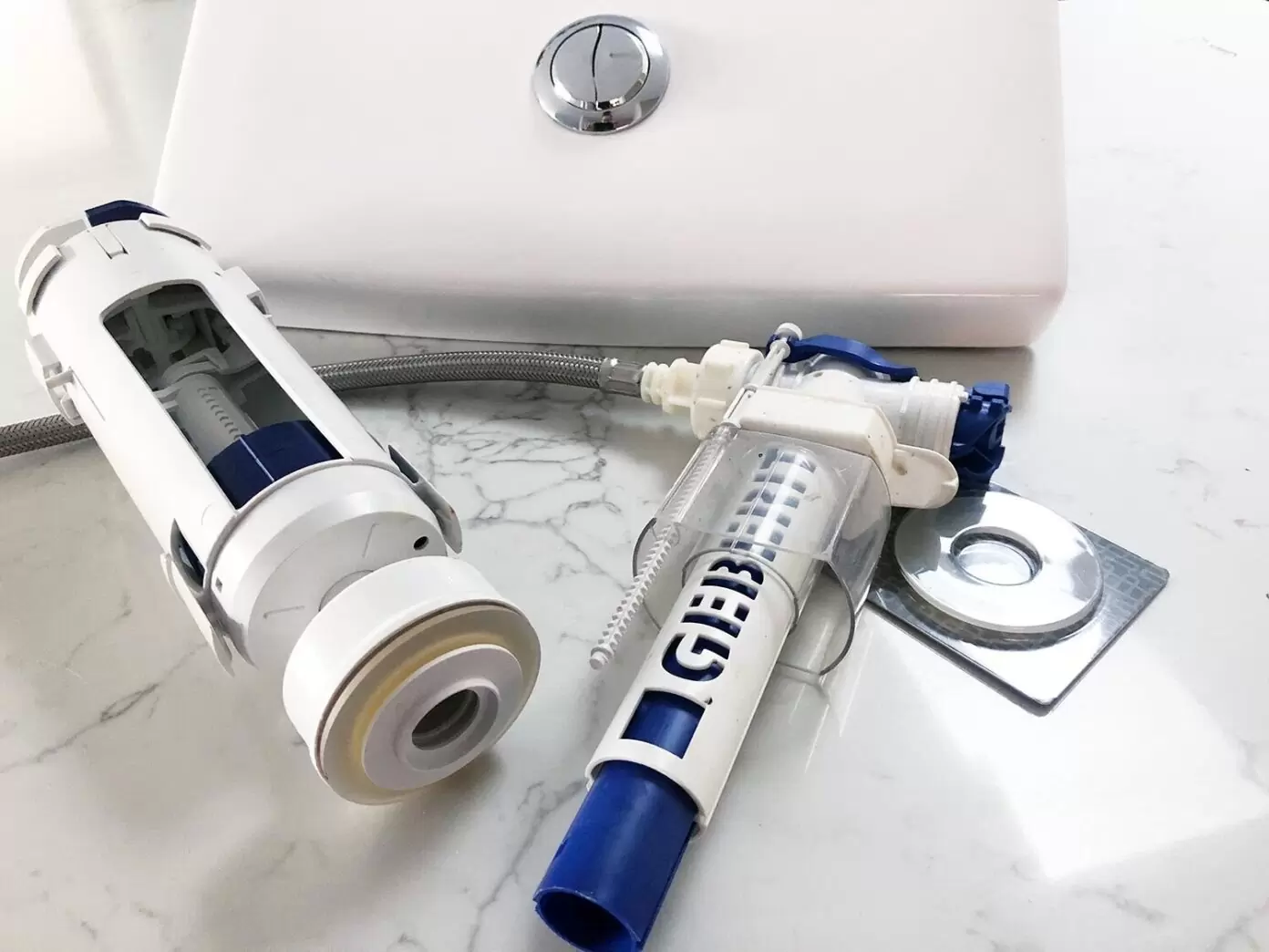 Common toilet cistern parts including inlet and outlet valve, flush button, and braided hose
