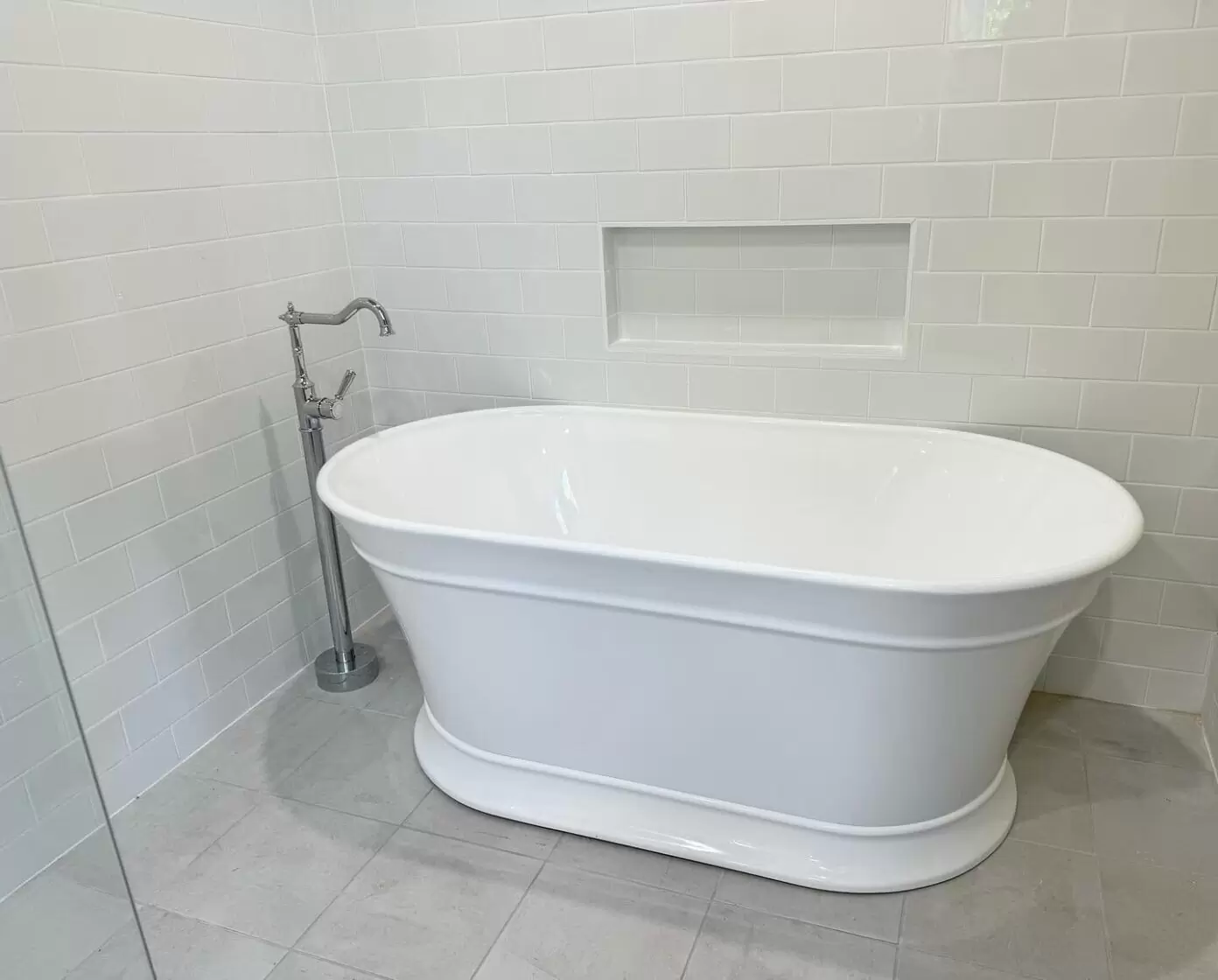 Classic freestanding bath with chrome floor-mounted tapware installed in Brisbane