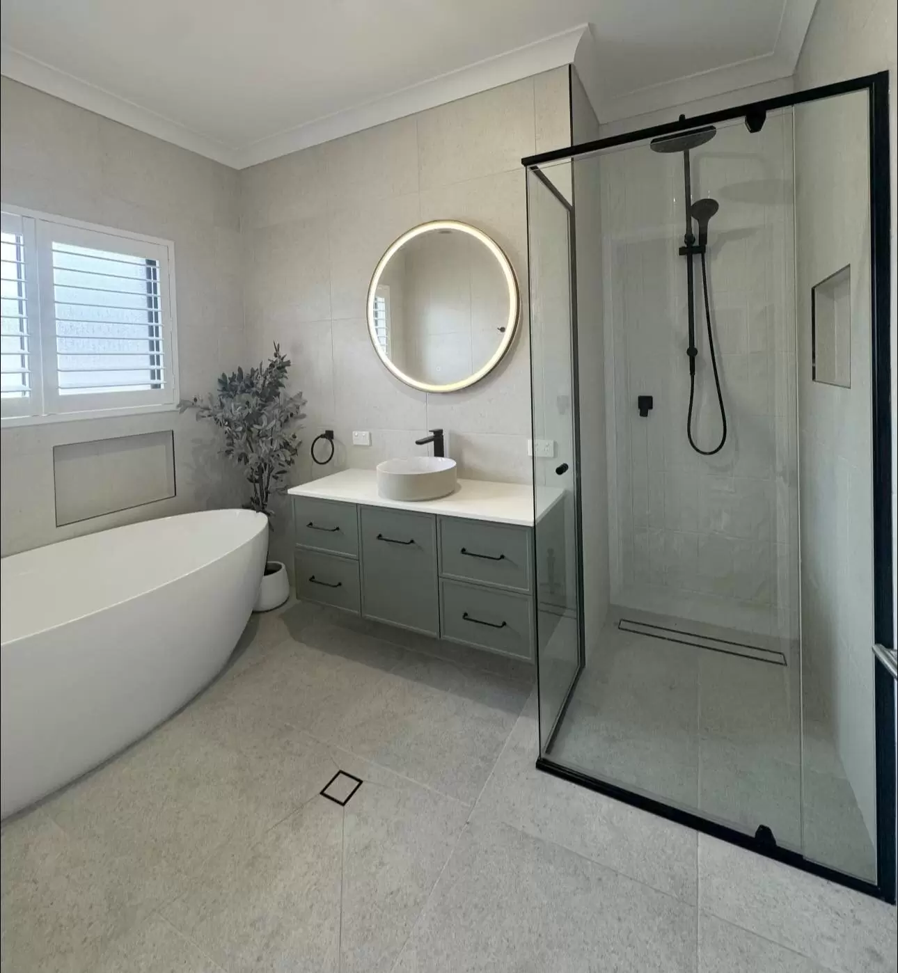 Stylish bathroom featuring circular LED mirror and black fittings – Upper Coomera