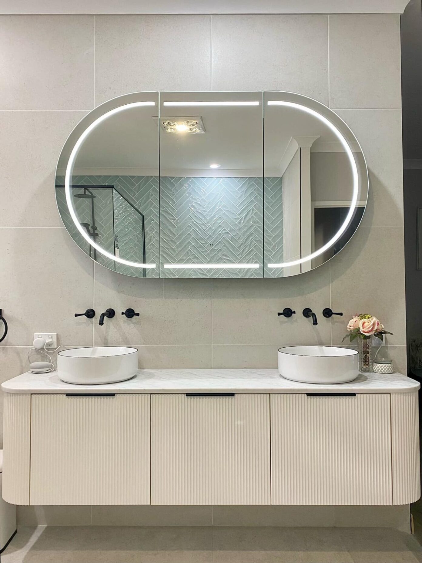 Stylish bathroom featuring circular LED mirror and black fittings – Upper Coomera