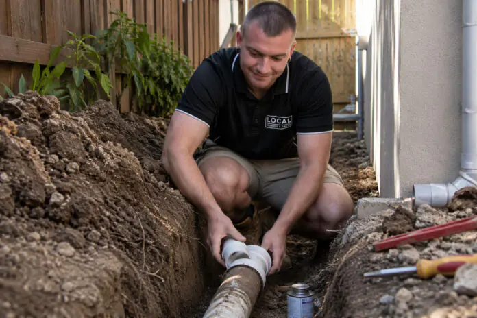 Local Plumbing & Gas Co. plumber repairing an underground sewer pipe on the Gold Coast