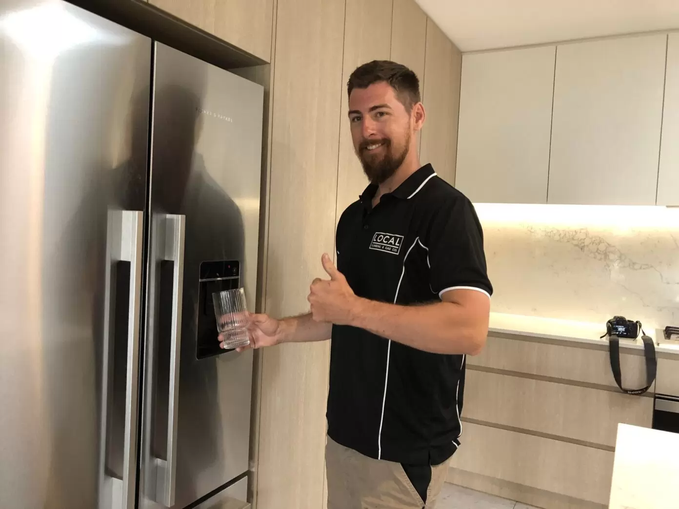 Plumber connecting fridge water line for filtered water and ice dispenser