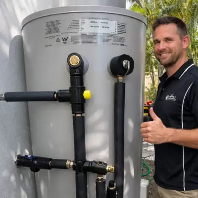 professional plumber installing a new hot water system on the Gold Coast