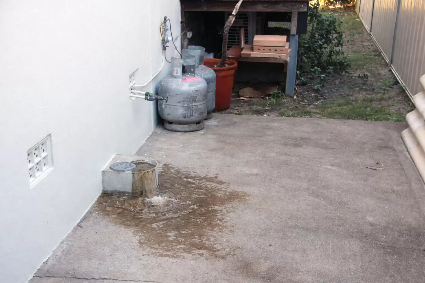 overflow relief gully discharging wastewater due to blocked main sewer line