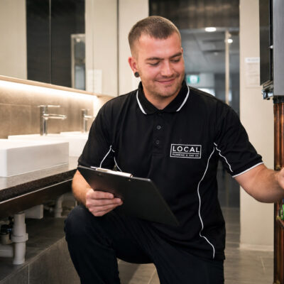 Gold Coast commercial plumber inspecting restroom plumbing and pipework