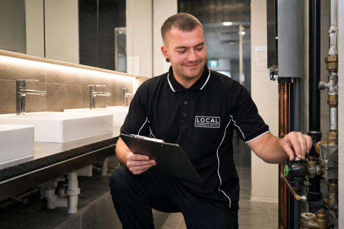Gold Coast commercial plumber inspecting restroom plumbing and pipework