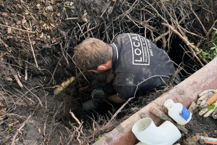 plumber completing a pipe repair at a Gold Coast home